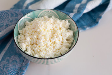 cup of cottage cheese in a cup on a white background