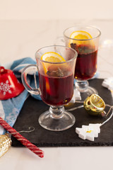 mulled wine of red wine and spices and orange and Christmas decorations on a white background