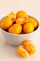 juicy tangerines in a plate on a white background close-up