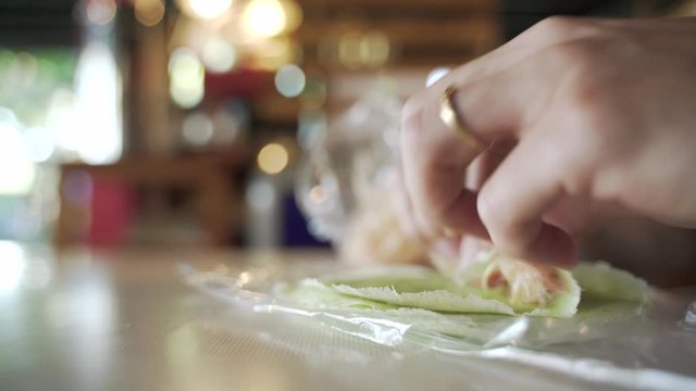 Hand folding Roti Sai Mai or cotton candy floss treat, a Thai traditional dessert in Ayutthaya province