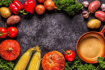 Fresh autumn vegetables for cooking on a dark background.