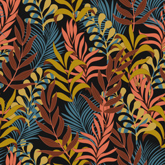 Abstract seamless tropical pattern with bright red and yellow plants and leaves on dark background.  Seamless exotic pattern with tropical plants.  Tropic leaves in bright colors.