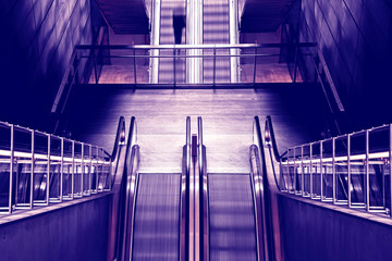 Abstract image with black silhouette on the subway escalator as a symbol of moving forward, getting out of depression, advancing and achieving life goals