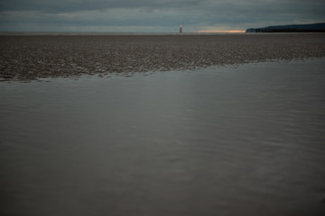 Lighthouse seen shining from Camber Sands beach