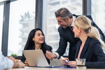Corporate business team and manager in a meeting.Young team of coworkers making great business discussion in modern coworking office.Teamwork people concept