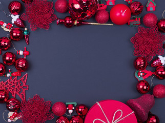 Red and gold Christmas balls on black background, top view , copy space, flat lay