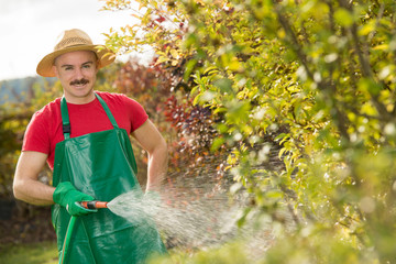 Gärtner mit Gartenschlacuh