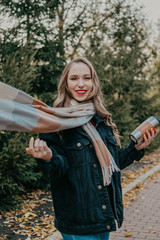 Young beautiful woman with reusable coffee cup walks in fall autumn park. Environmental friendly, eco living, No plastic, Zero waste, slow living concept