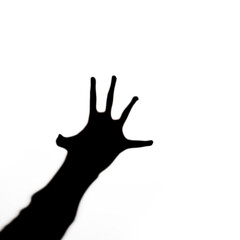 Obraz premium Black silhouette of human hand with spread fingers stretches like in horrors