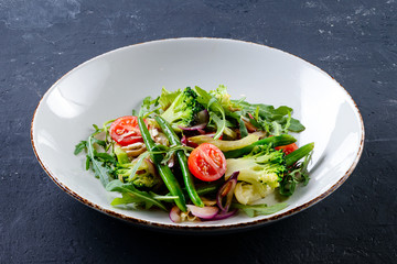 Fresh broccoli salad with cherry tomatoes mix and arugula