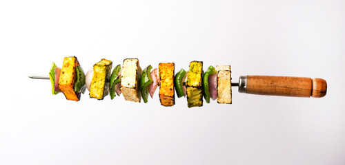 Flying Paneer Tikka isolated over white or black background, selective focus