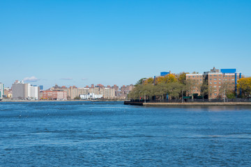 Fototapeta na wymiar Shoreline of Astoria Queens New York with the East River and the Shore of Manhattan