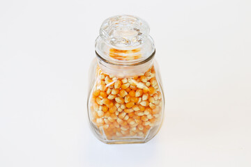  Corn kernels in a jar on a white background