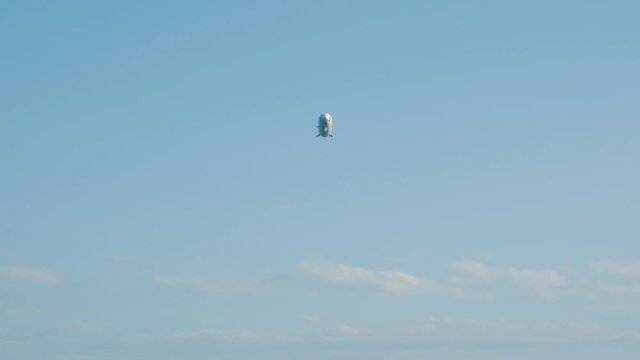 Airship dirigible in the air flies in the blue sky