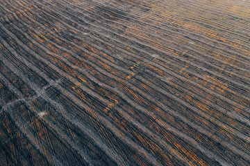 Aerial view of empty harvested field in late autumn. Agriculture farmland background