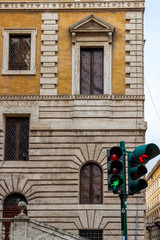 Obraz premium Traffic lights in front of the The Piccola Farnesina, seat of Museo Barracco di Scultura Antica or Barracco Museum of Antique Sculpture in Rome, Italy 