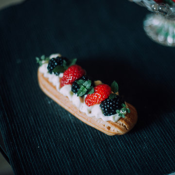 Sweet handmade eclair at the table