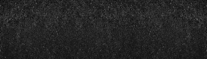 Old black concrete wall wide texture. Rough dark cement large backdrop. Gloomy grunge abstract background