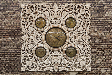 Fototapeta na wymiar Wall mounted clocks old vintage gothic concept of numbers and shape our hands on a brick wall