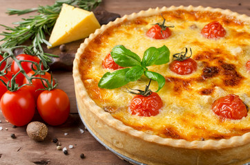 Freshly baked homemade pie quiche Lorraine on a wooden table