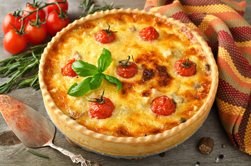 Freshly baked homemade pie quiche Lorraine on a wooden table