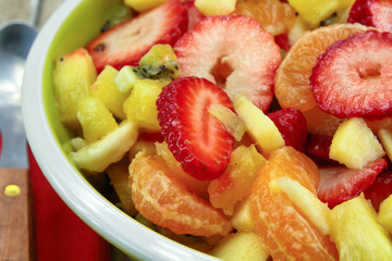 plate of fresh fruit salad on a wooden table