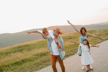 Happy smiling family spending summer day at park.