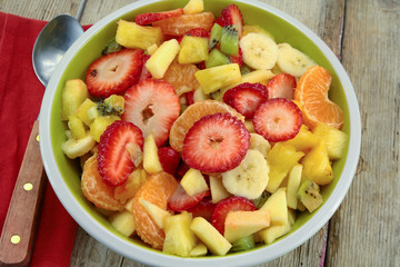 plate of fresh fruit salad on a wooden table