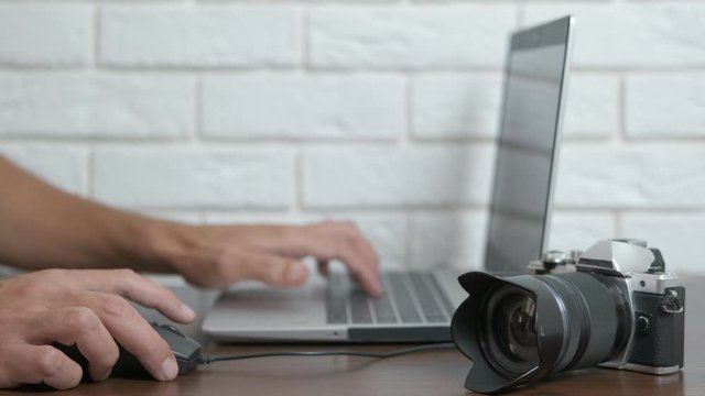 Photographer with a computer. Photographer with laptop and camera.