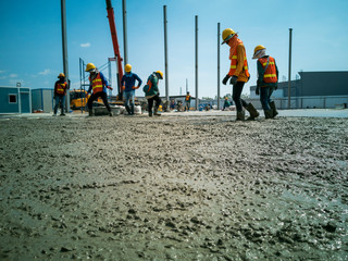 worker is walk on wet concrete, Near distance of acceptable sharpness style, laborer is move on...