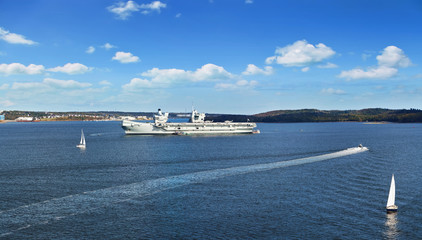 Panoramic view of Halifax Harbor with military ship and sail boats on sunny day