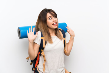 Young traveler woman over white background with surprise facial expression