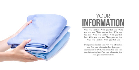 Stack blue folded clothing in hand on white background isolation, space for text