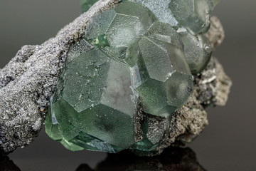 macro mineral stone green fluorite on a black background