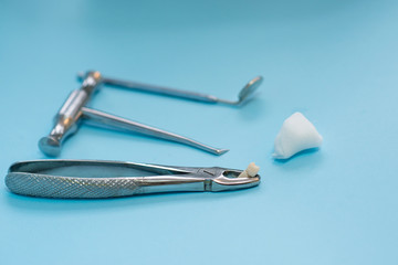 extraction of a diseased tooth, tools of a stamotologist in a stomatologist’s office for dental treatment of caries