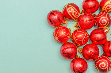 Christmas background with copy space. Top view of Christmas red balls on light blue background. Copy space.