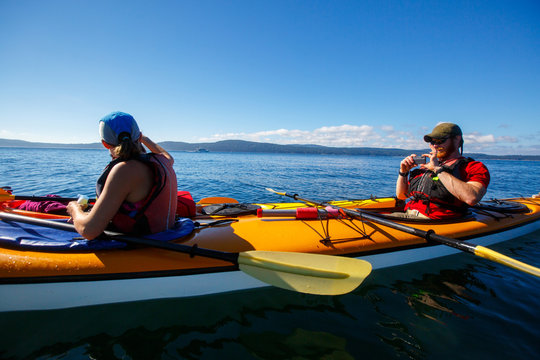 Photo op. A man takes a photo of a woman during a 3-day tandem kayaking trip in the San Juan Islands of northwest Washington.