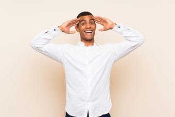 Young handsome brunette man over isolated background with surprise expression