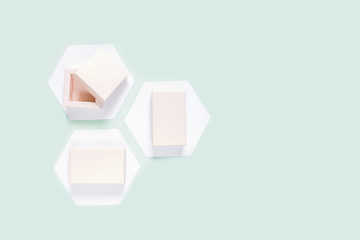 Festive neo mint flat lay. Set of gift boxes on white hexagons hexagons on a neo mint background, birthday, wedding day, mother's day, valentines day, greeting card.