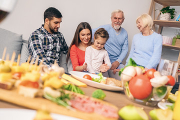 Family after dinner plays with the child and rests