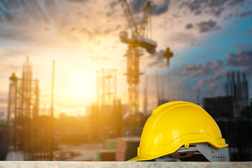 Construction safety concept, yellow hard safety helmet hat in construction site