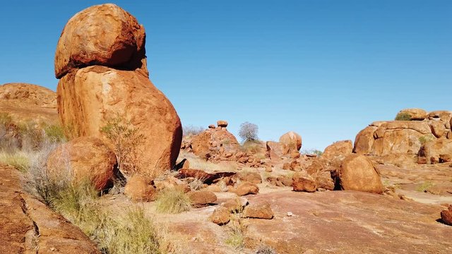 Sunrays at sunset light in Karlu Karlu - Devils Marbles Conservation Reserve. Australian Outback landscape in Northern Territory, Australia near Tennant Creek. Aboriginal land in Red Centre.
