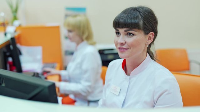 Female receptionist in hospital. Smiling female receptionist at the reception desk