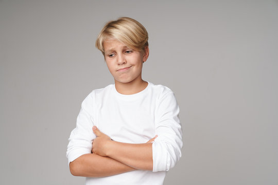Сute little blonde boy wearing sweatshirt standing