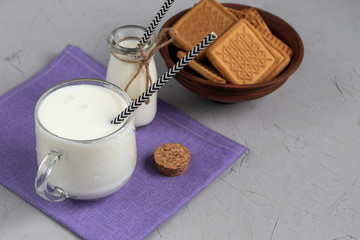 Kefir, a fermented drink with probiotics. Useful and fashionable sour-milk food and drinks. Light background. Paper tube. Copy space. 