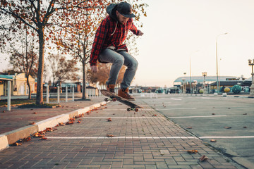 Skateboarding. A man does an Ollie stunt on a skateboard. Jump in the air. Street on the background