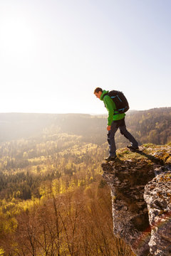 Albstatt-Onstmettingen, Baden-W&cedil;rttemberg, Germany: A male hiker on the "Hangender Stein" cliff along the "Traufgang Zollernburg-Panorama" trail.