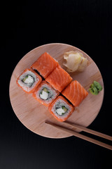California sushi rolls on dark wooden table