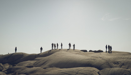 Fototapeta na wymiar Silhouette of people on a rocky landscape 