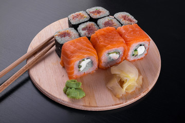 California sushi rolls on dark wooden table